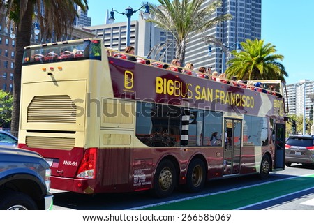 SAN FRANCISCO, CA - MARCH 29, 2015: Passengers riding on the top tier of a double-decker tour bus are treated to a magnificent view of the city.