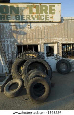 Tractor tires in various stages of repair at a country tire store