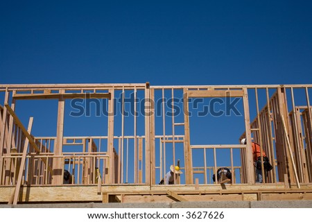 Workmen are rough framing a new two-story house