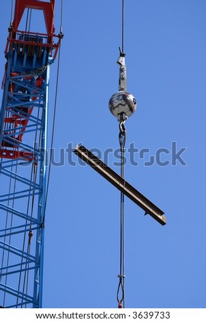 Luffing jib crane easily lifts heavy beam onto new high rise building