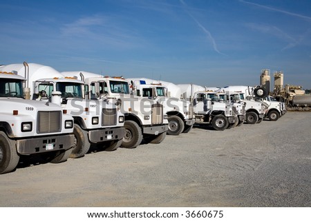 Transit mix concrete trucks ready to deliver their loads to construction job site