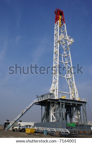 A very large oil well drilling rig sets up in kern County, California