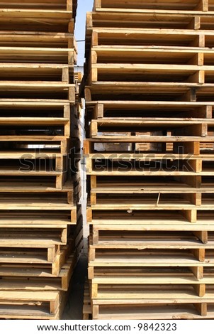 Stacks of wooden pallets at shipping facility