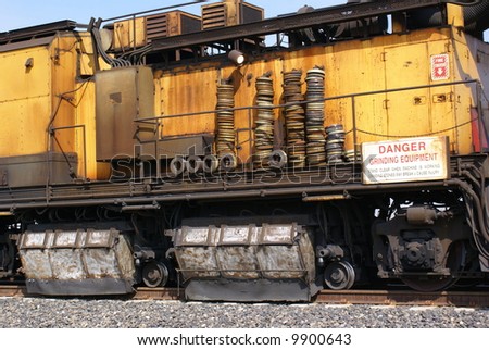 A track grinding train which grinds rails to provide longer service life