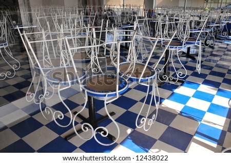 Chairs on tables for cleaning restaurant floors