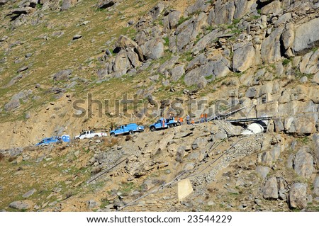 Utility company crew works near dam on the steep slopes of the Kern River Canyon, California