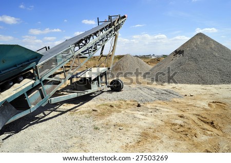 Conveyor belt and portable materials handling equipment used for aggregate (gravel) in a batch plant
