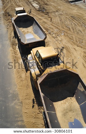 Large dump trucks are ready for big loads on construction job site