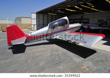 A sleek two-place home-built experimental airplane undergoing maintenance