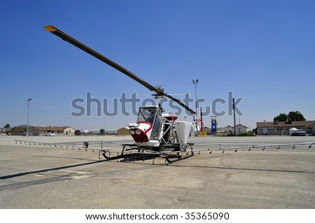 The crop duster is replaced with this small helicopter outfitted with liquid hoppers and spray nozzles