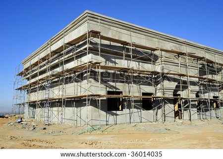 Scaffolding completely surrounds this newly constructed building so that plasterers can access the exterior walls