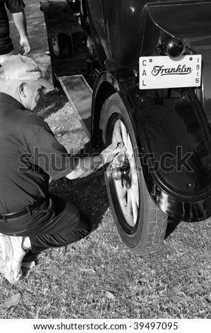 BAKERSFIELD, CA - OCT 24: A proud owner polishes his car\'s wooden wheels at the \