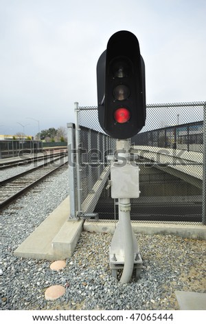 Railroad colored light signal (replacing old semaphor signals) shows red stop for oncoming trains