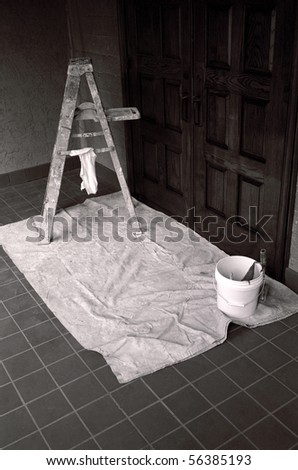 A painter\'s equipment: Stepladder, bucket and drop cloth