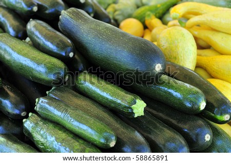Colorful produce on display at a farmers\' market: Green and yellow squash