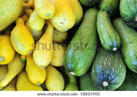 Colorful produce on display at a farmers\' market: Green and yellow squash