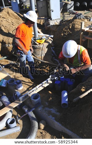 BAKERSFIELD, CA - AUG 12: Electricians completely replace traffic signals, poles and mast arms at a major intersection on August 12, 2010, at Bakersfield, California. Underground conduit is repaired.