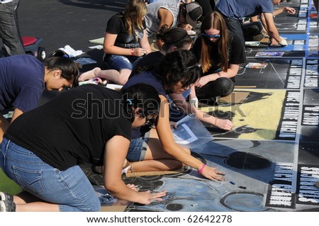 BAKERSFIELD, CA - OCT 9: Local students and artists apply chalk to asphalt for the Via Arte Italian Street Painting Festival on October 9, 2010, at Bakersfield, California