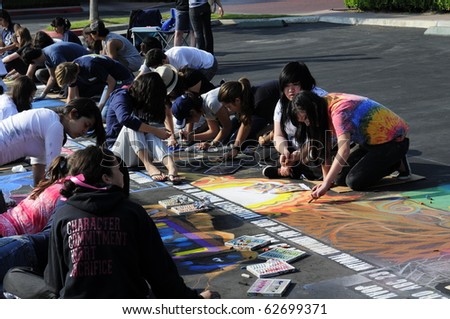 BAKERSFIELD, CA - OCT 9: Local students and artists apply chalk to asphalt for the Via Arte Italian Street Painting Festival on October 9, 2010, in Bakersfield, California