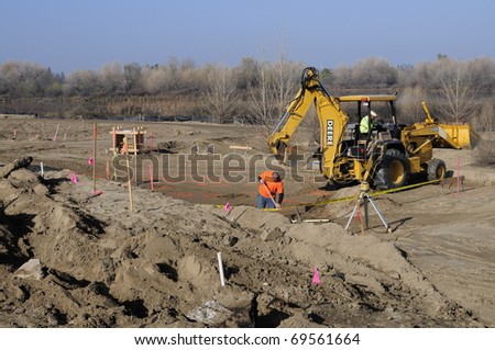 BAKERSFIELD, CA - JAN 22: Construction crew is installing underground utilities for the Kern River Upland and River Edge Restoration Project on January 22, 2011, at Bakersfield, California.