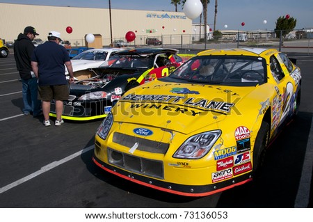 BAKERSFIELD, CA - MAR 12: NASCAR sponsor holds public auction for all their cars and parts on March 12, 2011 in Bakersfield, California. Buyers inspect racing cars prior to bid.