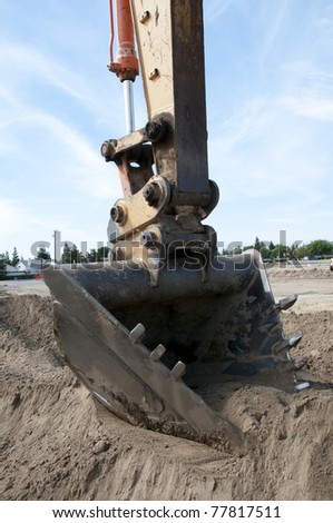 Heavy equipment prepares construction job site: Digging bucket
