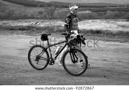 BAKERSFIELD, CA - JAN 14: An unidentified cyclist walks his bike to the start of the Rio Bravo Rumble biathlon (running and mountain biking) on January 14, 2012, in Bakersfield, California.