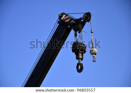 Hooks, ball and block and tackle on mast of crane used to lift large loads