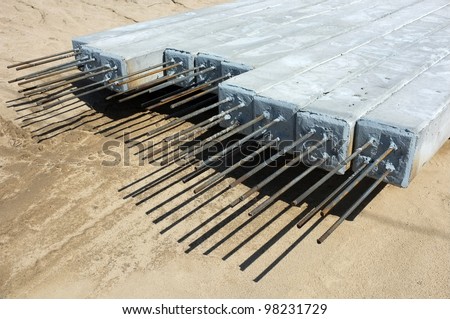 Contractor\'s lay down area for storage of precast concrete pilings used on a bridge construction project