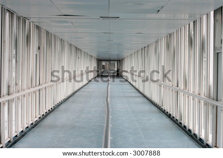 Very long corridor leading to another door.  This shows the feeling of walking down a long hallway.