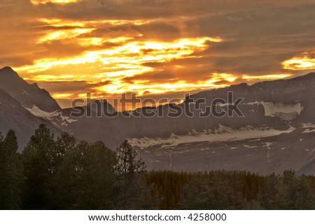 The sun sets behind the Rocky Mountain range in Lake Louise, Canada