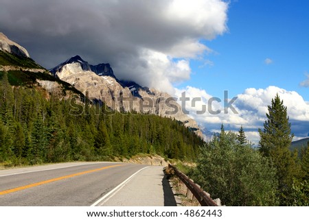 Nicely paved road into the mountains.  Conceptual idea for taking the high road or taking the road to the top.