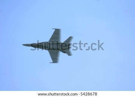 An F-18A Superhornet streaks by at the speed of sound.  The file contains motion blur for effect of speed.
