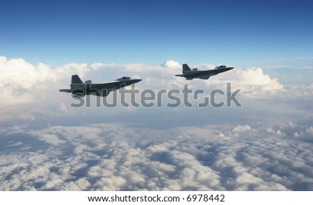 Two military jets flying together high above the clouds with a dark blue sky.