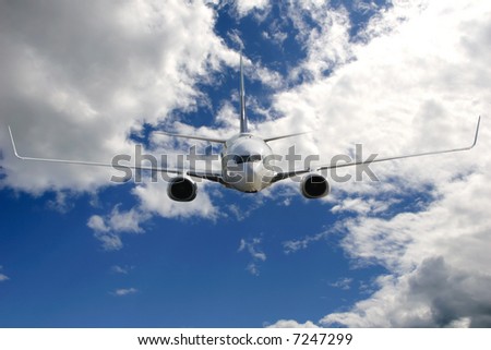 Photo of a commercial aircraft flying into the camera.  Plane is centered and horizontal in the frame.