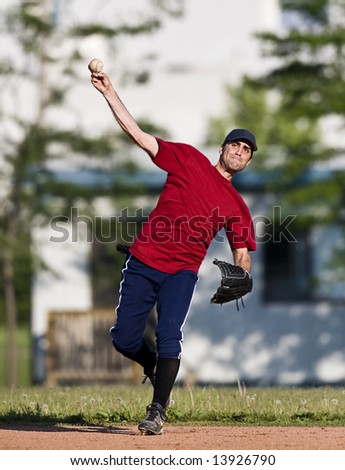 A baseball player throwing the ball during practice