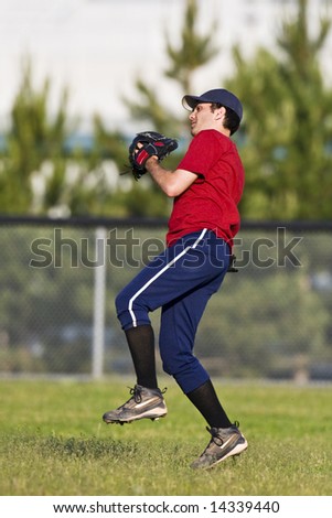 Baseball:  A player in the outfield prepares to throw the ball back in