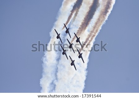 Stunt planes perform in tandem during an air show