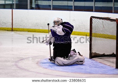 Hockey goalie making a save with his body