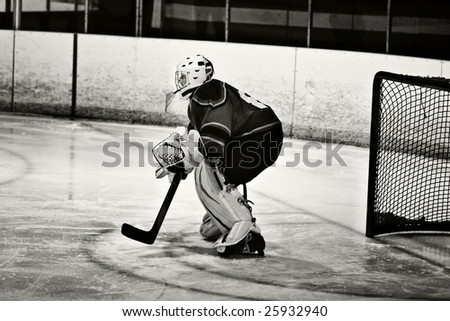 Ice hockey game action shot of the goalie