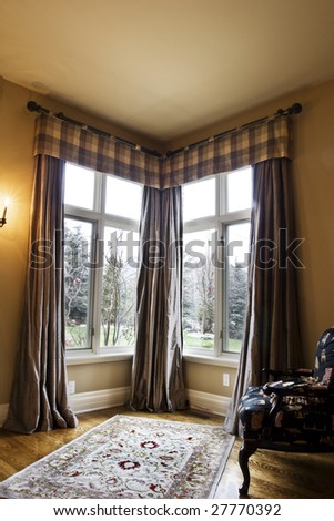 Corner window coverings using a wrought iron rod and puddled side panels