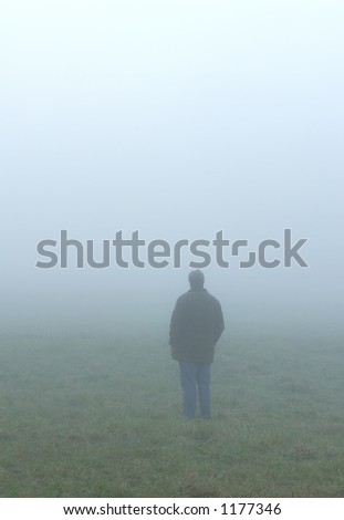 One man looking ahead into the fog.