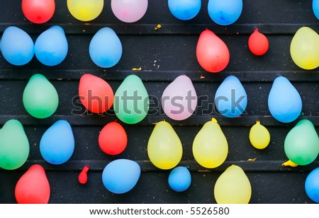 Balloons on a wall, part of a carnival dart game.