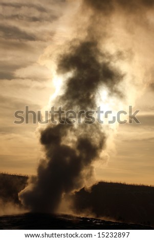 stock photo : Old Faithful Geyser at sunset - Yellowstone National Park.