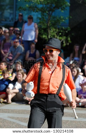 HALIFAX, CANADA - AUGUST 12: A street busker smiles at the crowd during a performance at the annual  summer Busker festival in Halifax Nova Scotia on August 12, 2011.