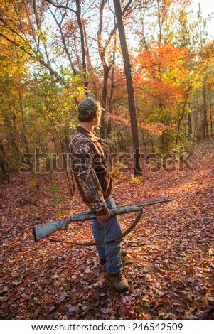 shotgun hunting for deer in a fall forest in geogia