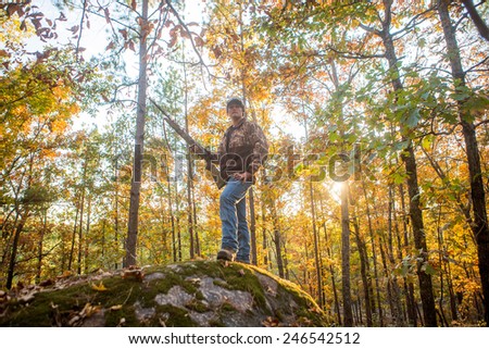 shotgun hunting for deer in a fall forest in geogia