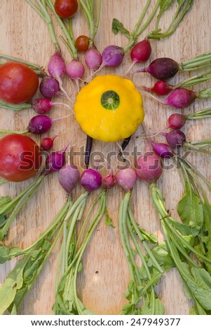 basket full of a variety of vegetables radishes, squash, tomato, cucumber, carrots, beets fresh local organic artisan farm grown produce georgia