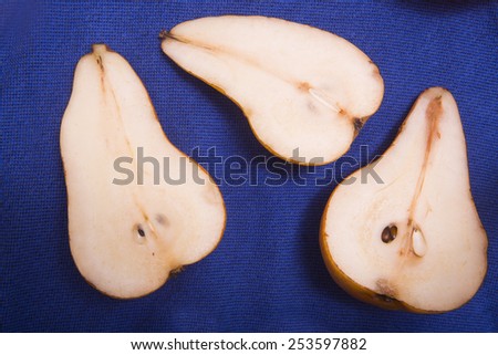 slices of pear on blue background