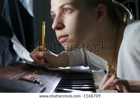A young woman writing music.